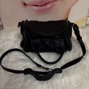 Alexander Wang Black  Textured Leather Handbag with top opening.